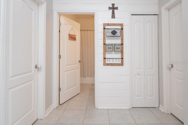 hall featuring light tile patterned flooring