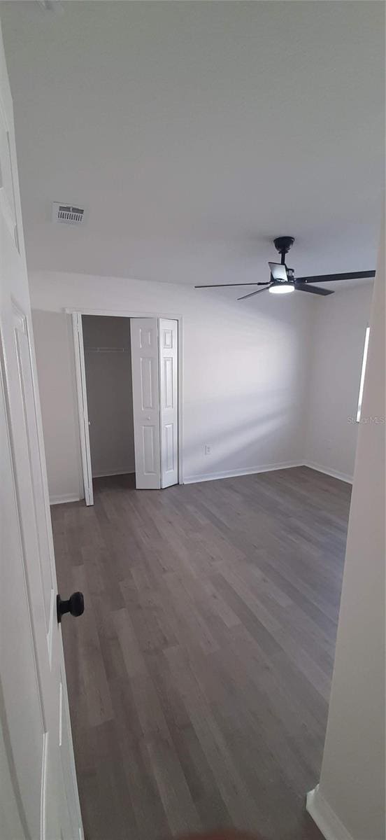 unfurnished room with wood-type flooring and ceiling fan