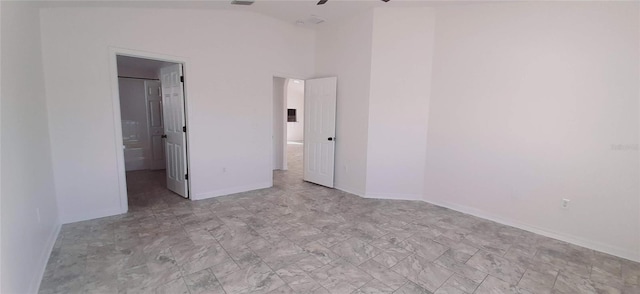 unfurnished bedroom with ceiling fan and vaulted ceiling