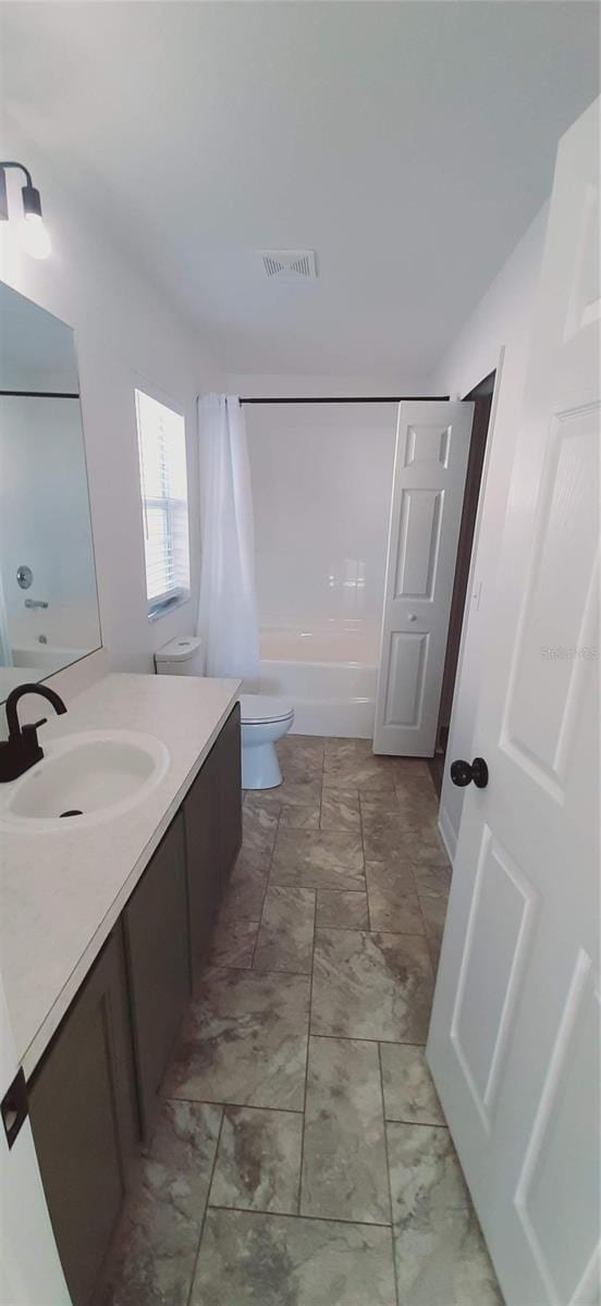 full bathroom featuring vanity, toilet, and shower / bath combo with shower curtain