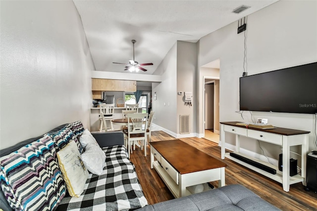 living room featuring ceiling fan, vaulted ceiling, and dark hardwood / wood-style flooring