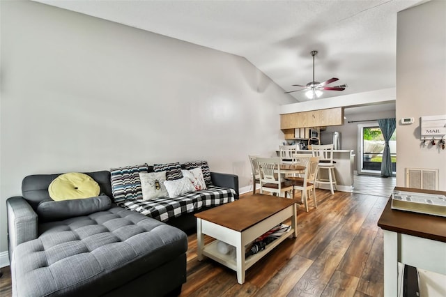 living room featuring ceiling fan, dark hardwood / wood-style flooring, and lofted ceiling