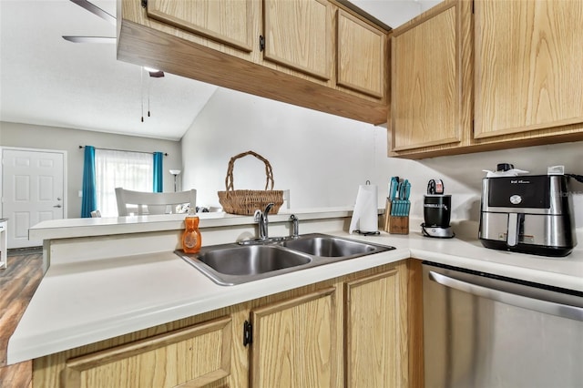 kitchen featuring kitchen peninsula, light brown cabinets, and stainless steel dishwasher