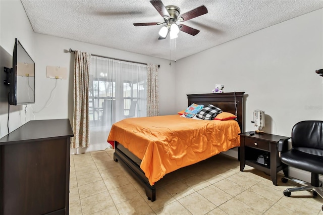 tiled bedroom with ceiling fan and a textured ceiling