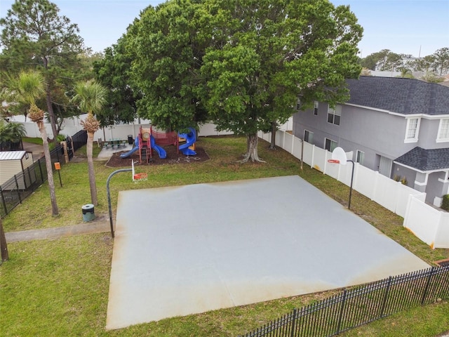 view of yard with a playground and basketball court