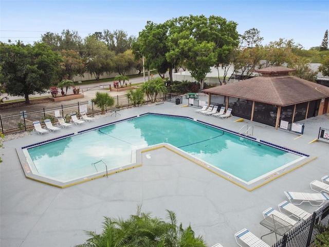 view of swimming pool featuring a patio and a gazebo