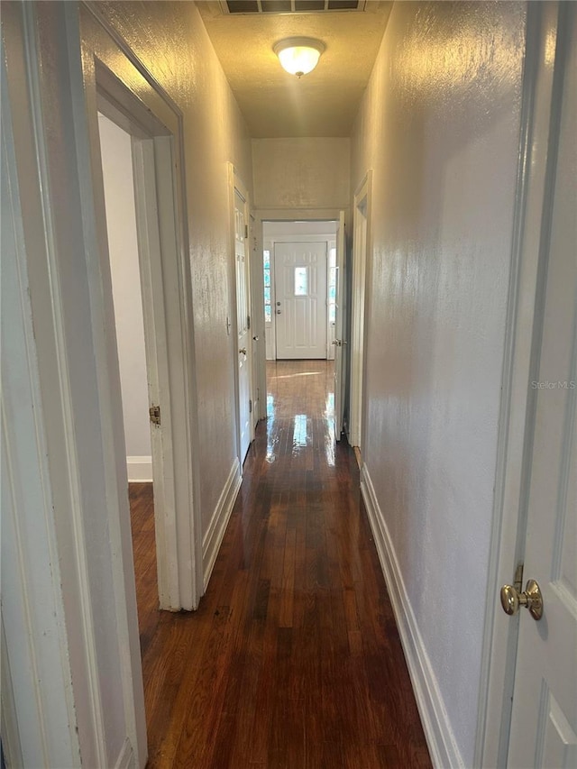 hall featuring dark wood-type flooring