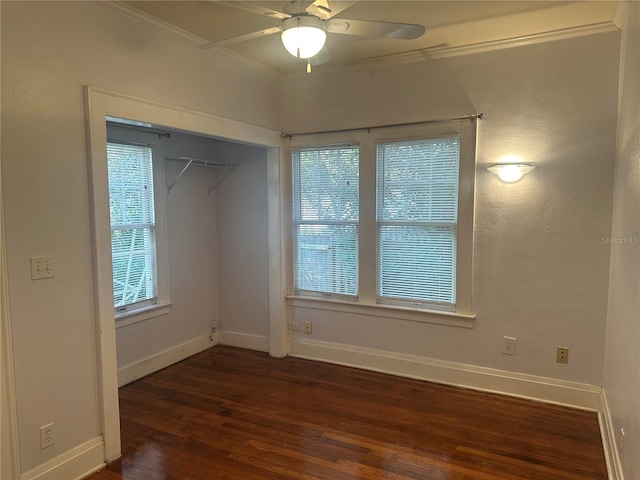 unfurnished room with crown molding, ceiling fan, and dark hardwood / wood-style floors