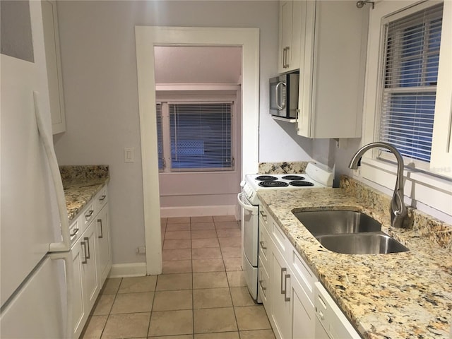 kitchen featuring sink, white appliances, white cabinets, and light tile patterned flooring