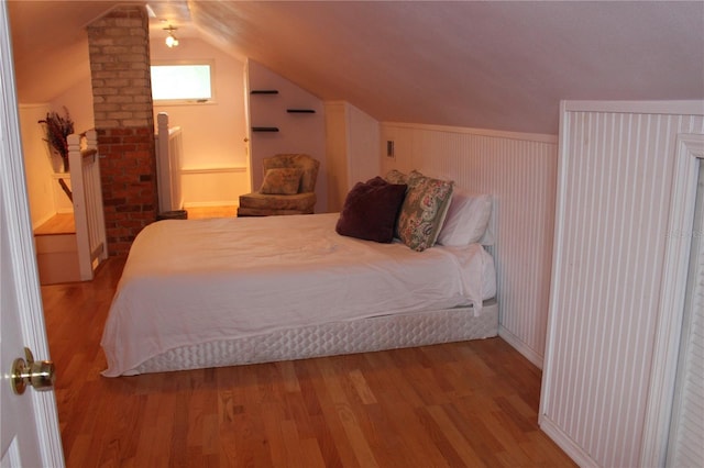 bedroom featuring vaulted ceiling and light hardwood / wood-style floors