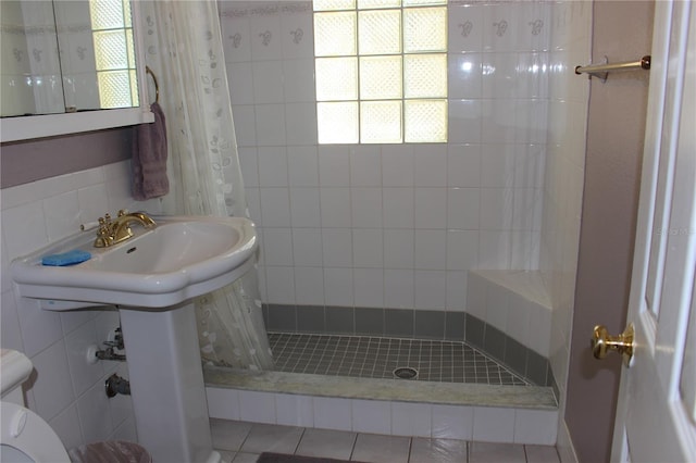 bathroom featuring walk in shower and tile patterned flooring