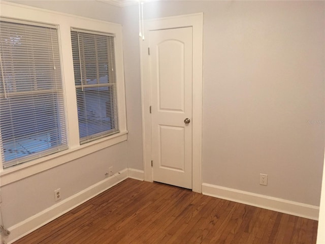 empty room featuring dark wood-type flooring