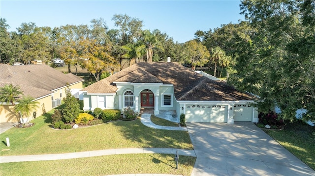 view of front of property with a garage and a front yard