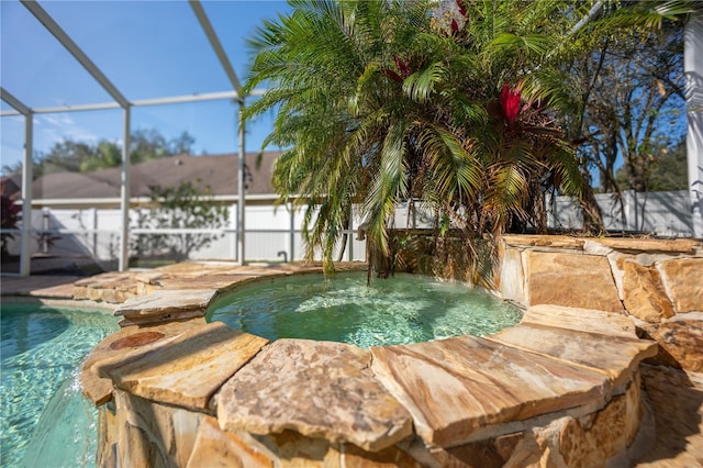 view of pool featuring glass enclosure