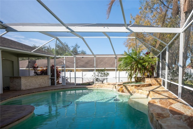 view of swimming pool featuring an in ground hot tub, pool water feature, a lanai, and a patio