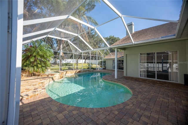 view of swimming pool featuring a lanai and a patio