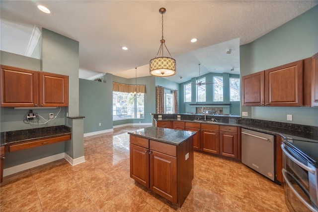 kitchen featuring a healthy amount of sunlight, appliances with stainless steel finishes, sink, and vaulted ceiling