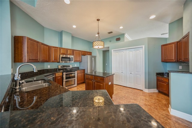 kitchen featuring sink, light tile patterned floors, appliances with stainless steel finishes, a kitchen island, and pendant lighting