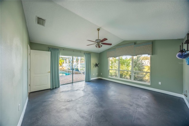 spare room with lofted ceiling, a textured ceiling, and ceiling fan