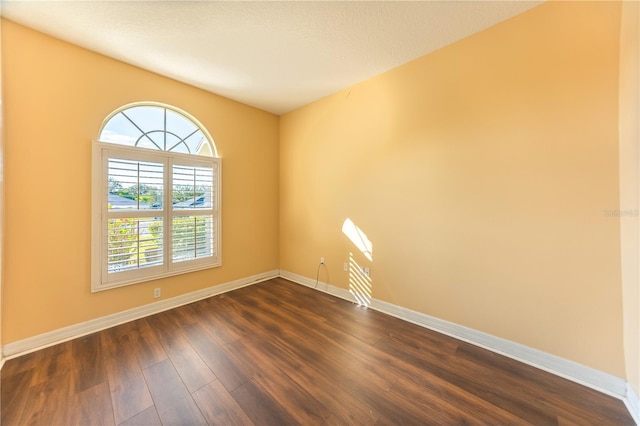 unfurnished room featuring dark hardwood / wood-style floors