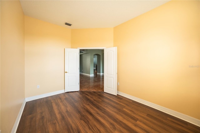 empty room with dark hardwood / wood-style floors