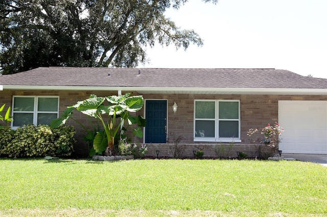 ranch-style home with a front yard and a garage