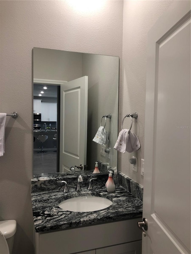 bathroom with toilet and vanity