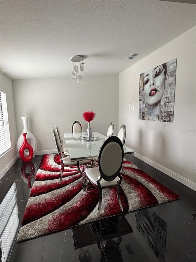 dining room with a textured ceiling