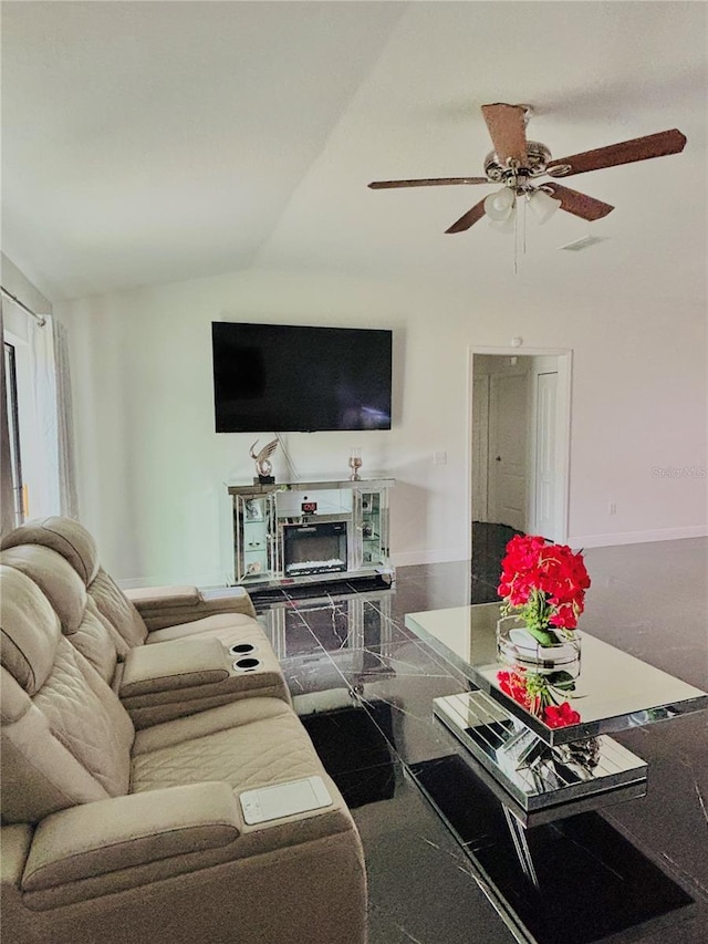 living room featuring a fireplace, vaulted ceiling, and ceiling fan