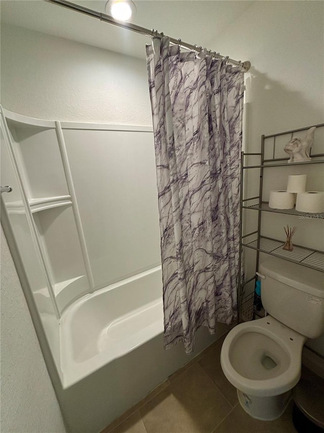 bathroom with toilet, shower / tub combo, and tile patterned flooring