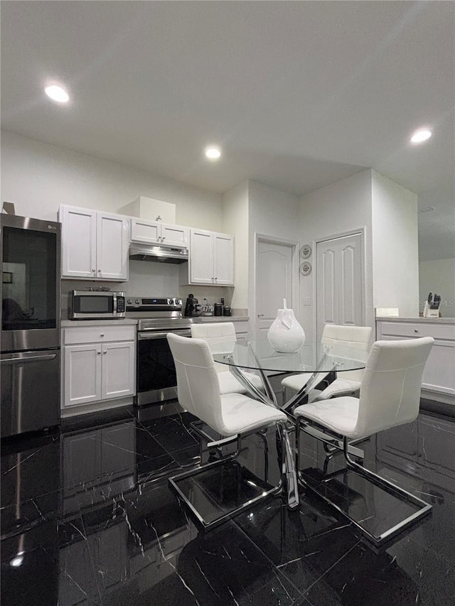 kitchen with white cabinetry and appliances with stainless steel finishes