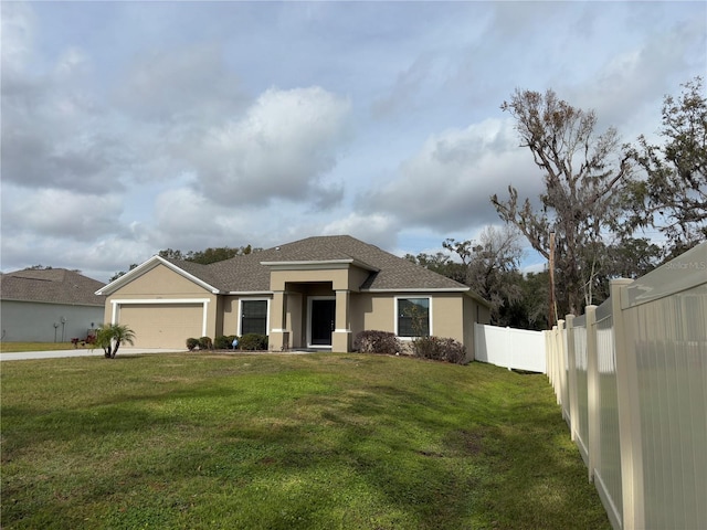 view of front of house featuring a front yard and a garage