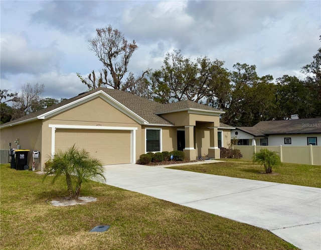 view of front of home featuring a garage and a front yard