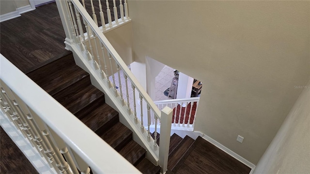 stairway featuring wood-type flooring