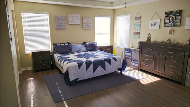 bedroom with dark wood-type flooring