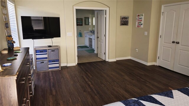 bedroom with dark hardwood / wood-style flooring