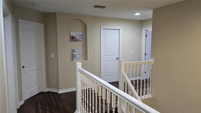 hallway with dark hardwood / wood-style floors