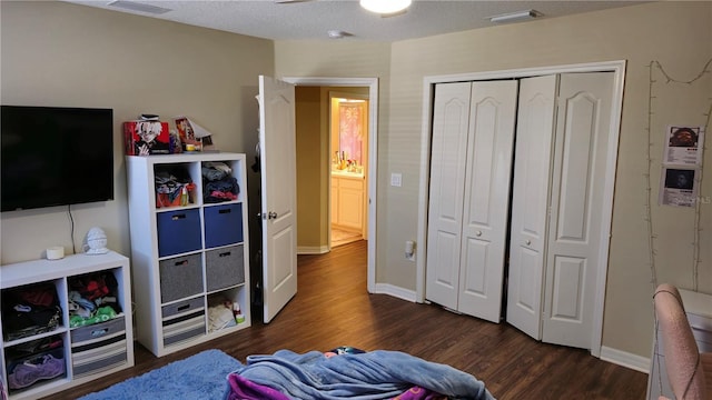 bedroom featuring dark hardwood / wood-style floors, a closet, and a textured ceiling