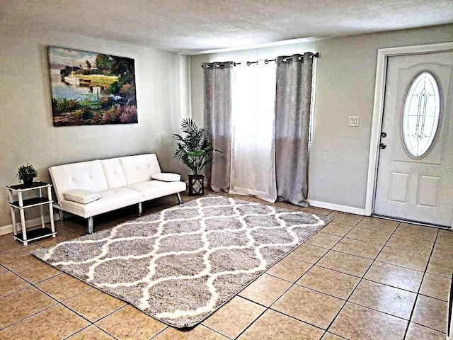 entrance foyer featuring tile patterned flooring and a textured ceiling