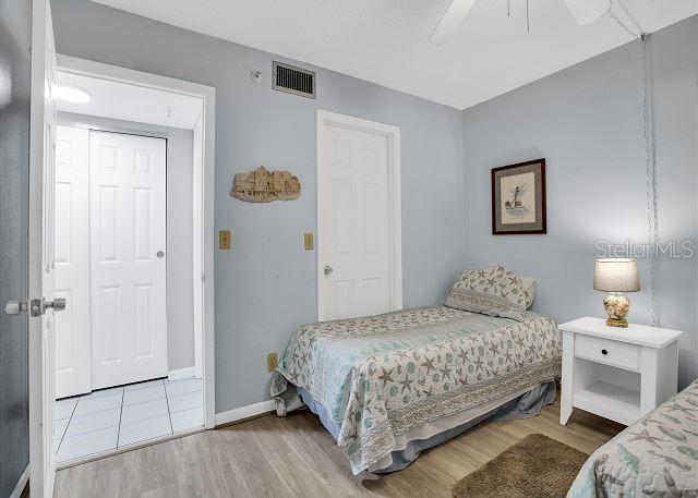 bedroom with hardwood / wood-style flooring and ceiling fan