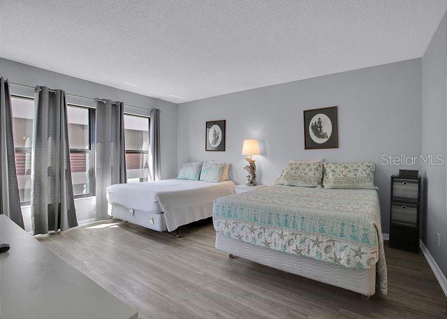 bedroom featuring dark wood-type flooring and a textured ceiling