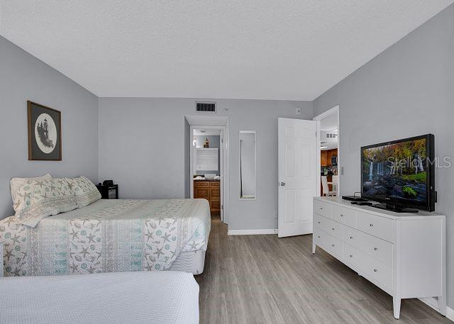 bedroom with hardwood / wood-style flooring and a textured ceiling