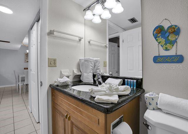 bathroom with vanity, tile patterned flooring, and toilet