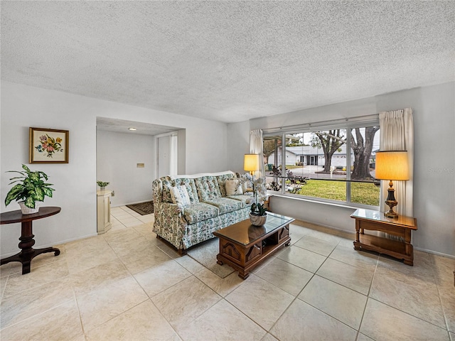 living room featuring light tile patterned floors and a textured ceiling