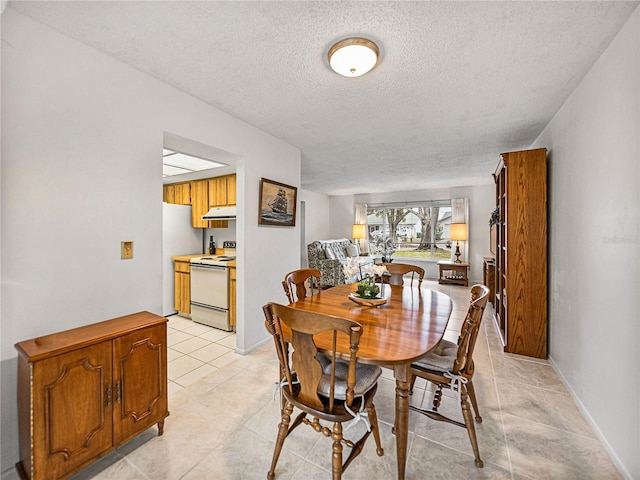 dining area with light tile patterned flooring and a textured ceiling