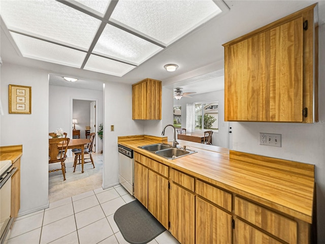 kitchen with sink, light tile patterned floors, dishwasher, ceiling fan, and stove