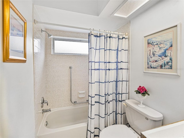 bathroom featuring shower / tub combo and toilet