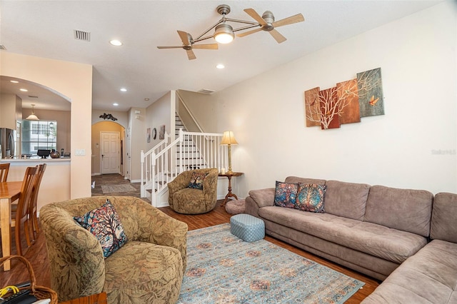 living room featuring wood-type flooring and ceiling fan