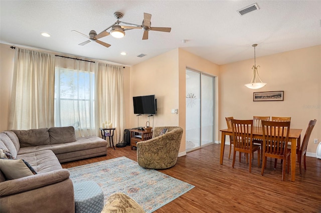 living room with hardwood / wood-style flooring and a textured ceiling