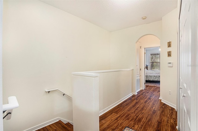 hall featuring dark hardwood / wood-style floors and a textured ceiling